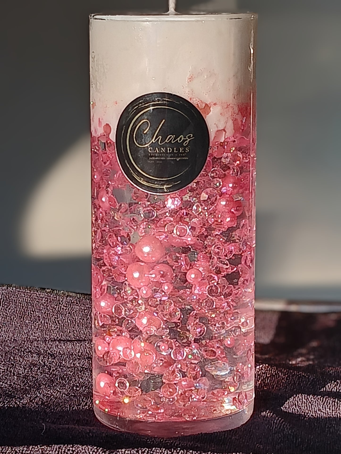 Blush pink luxury cylinder candle with soy wax top and suspended pearl accents, hand-poured by Chaos Candles in California.