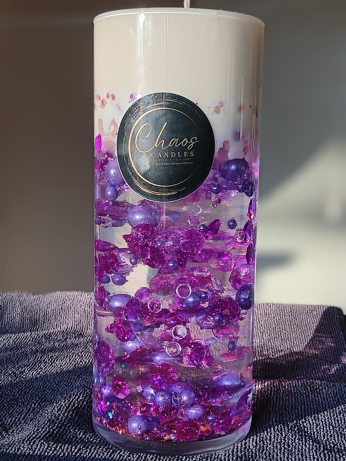 Calming Lavender luxury decor candle in a tall glass cylinder with suspended purple beads and soy wax top – hand-poured by Chaos Candles in California.